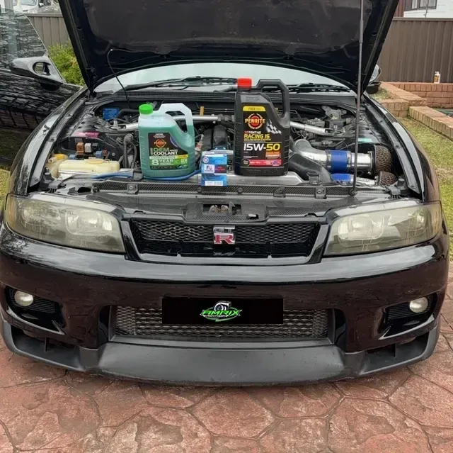 Black Car With Hood Open, Showing Engine and Oil Change Supplies — Amrix Automotive In Sefton, NSW