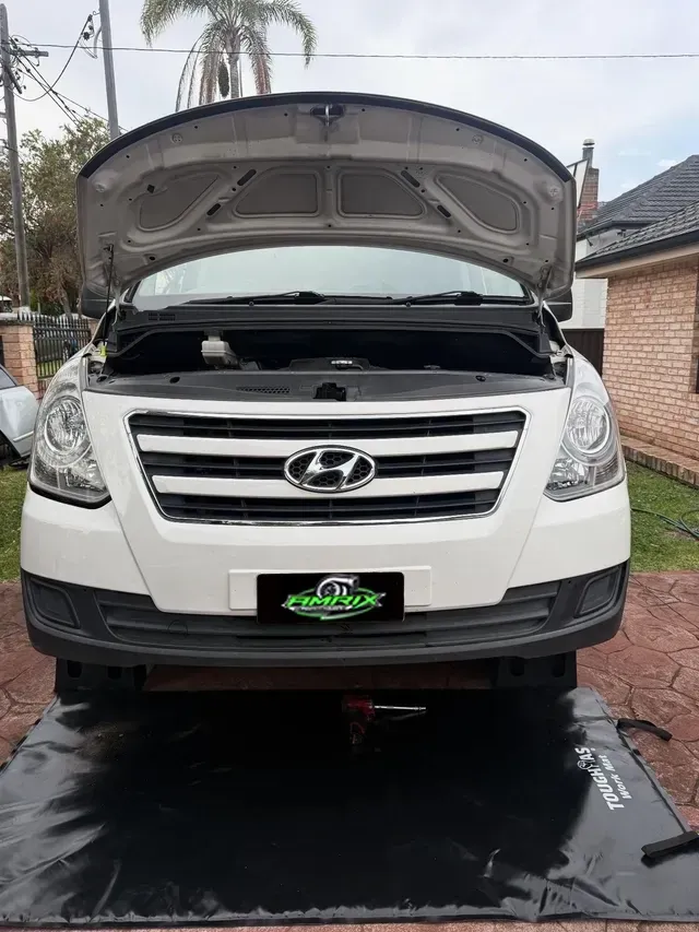 White Hyundai Van With Open Hood, Parked on a Mat in Front of a House — Amrix Automotive In Sefton, NSW