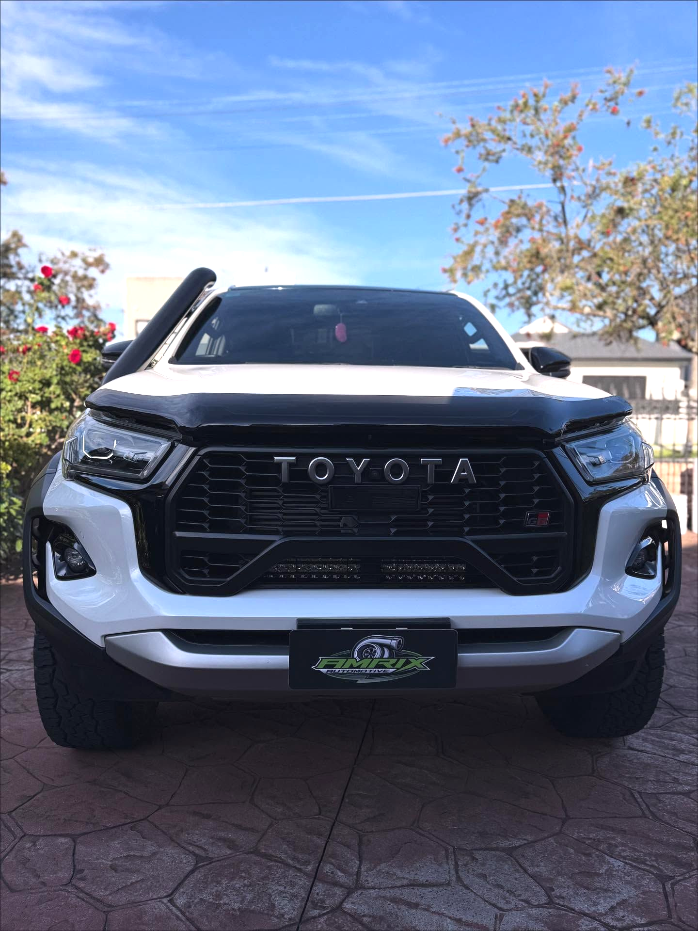 White Hyundai van with open hood parked on a black mat, outdoors  — Amrix Automotive In Sefton, NSW