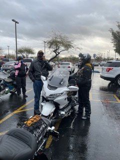 Members Standing by Motorcycle