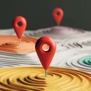 Red location pins marking points on a layered, topographic-style landscape with orange, yellow, and white segments.