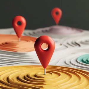 Red location pins marking points on a layered, topographic-style landscape with orange, yellow, and white segments.