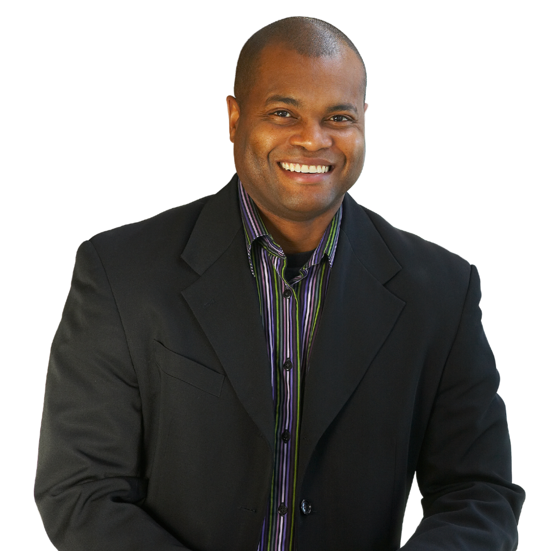 A man in a suit and striped shirt smiles for the camera