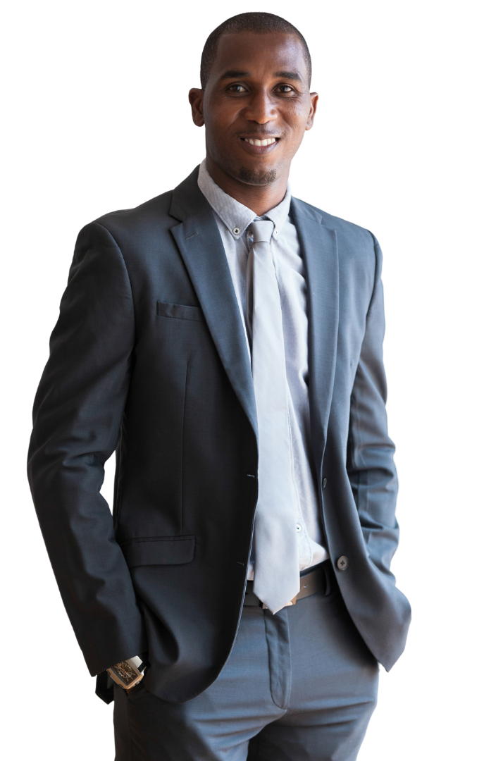 A man in a suit and tie is standing with his hands in his pockets.