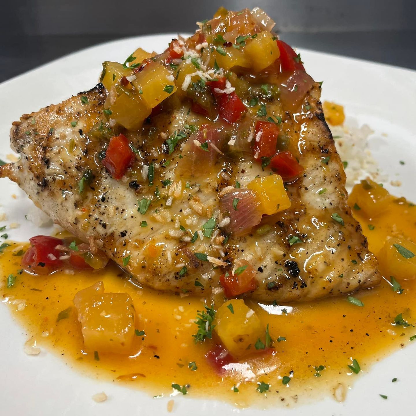 Wahoo fish cooked with tomatoes and onions