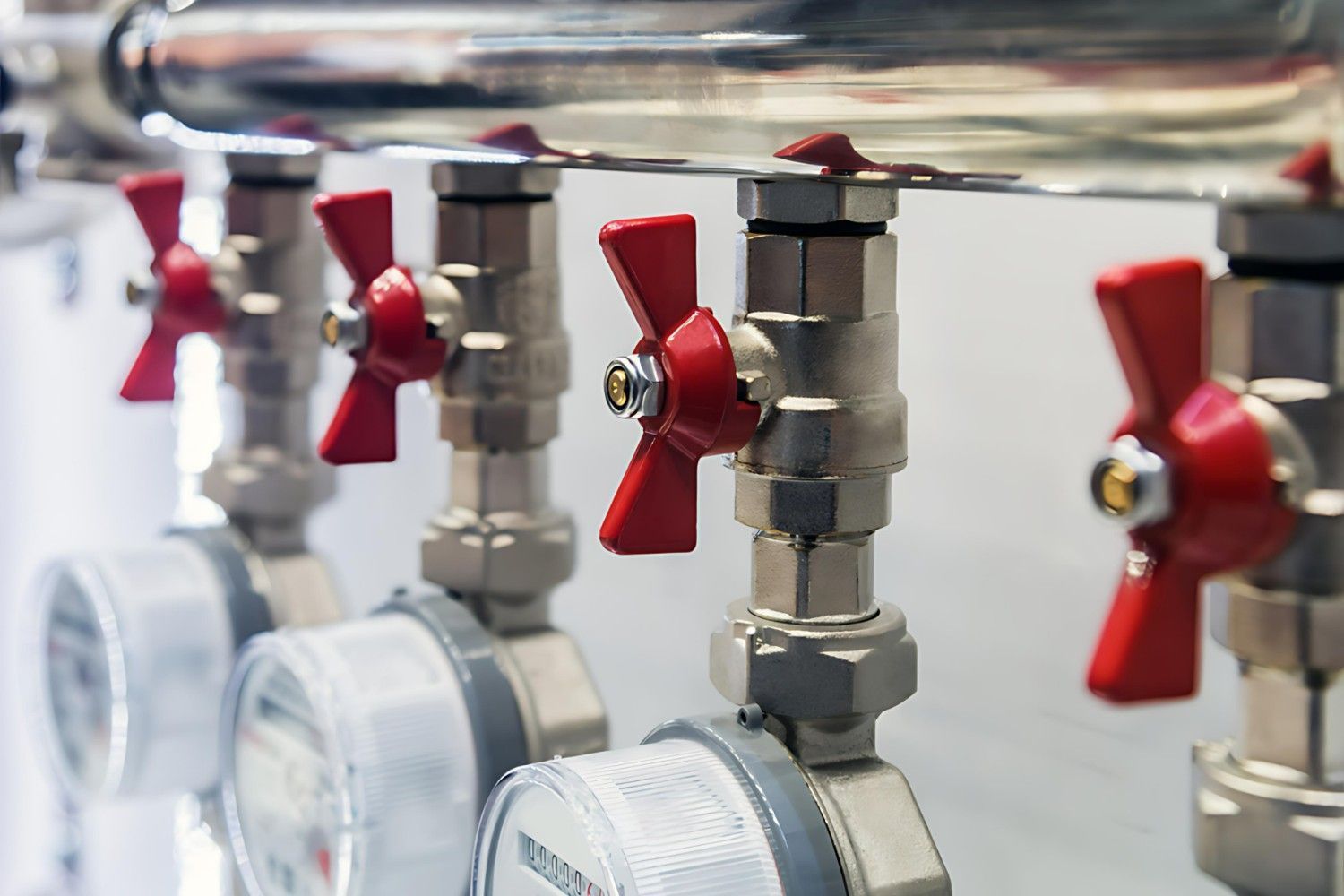 A Row of Valves and Gauges with Red Handles — B3 Plumbing in Flynn, ACT