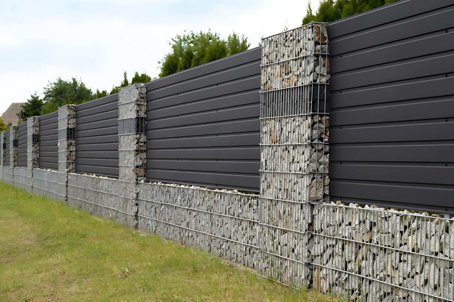 A Fence Made of Rocks and A Metal Fence — B3 Plumbing in Flynn, ACT
