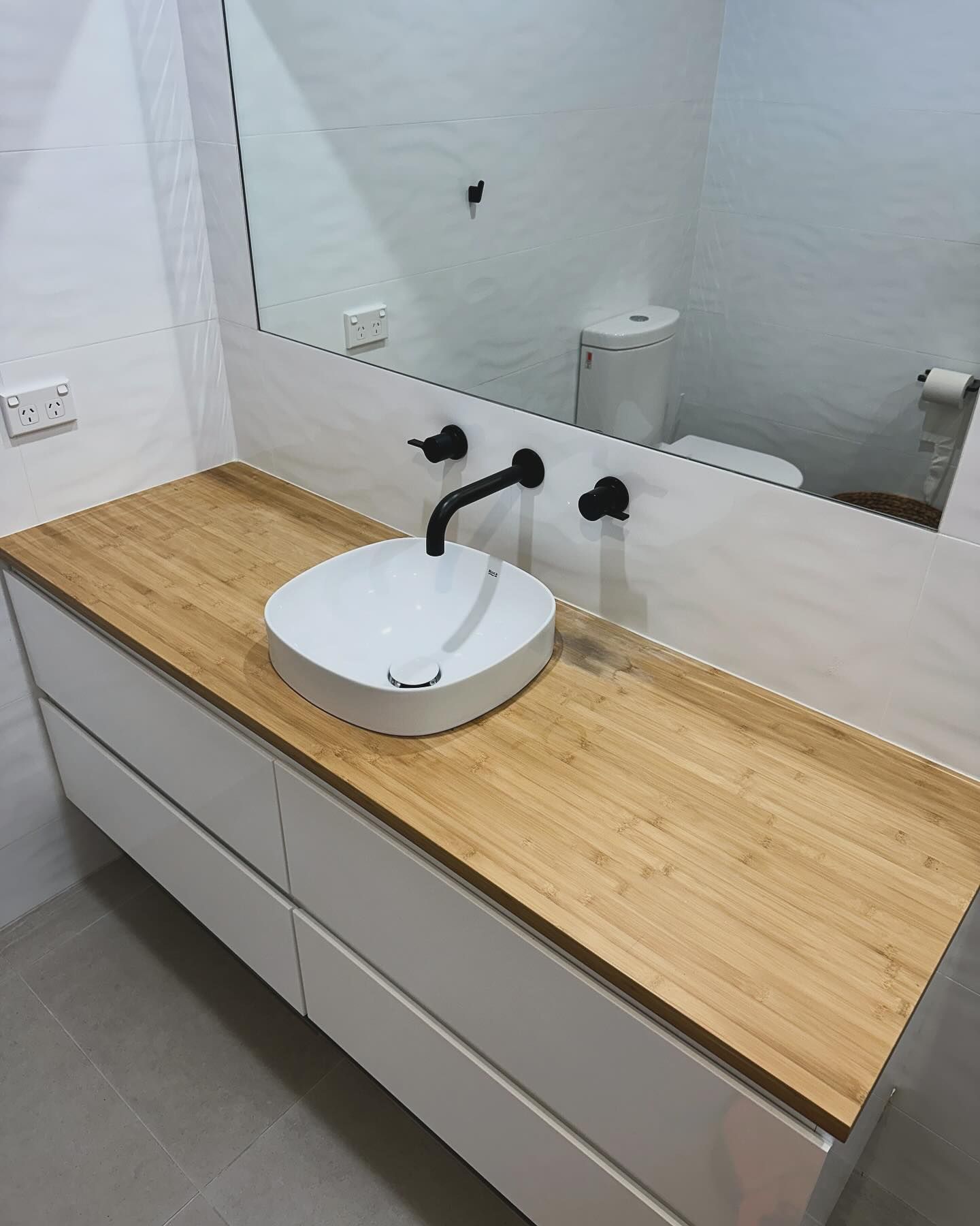 A Close up Of a Row of Pipes Attached to A Wall — B3 Plumbing in Flynn, ACT