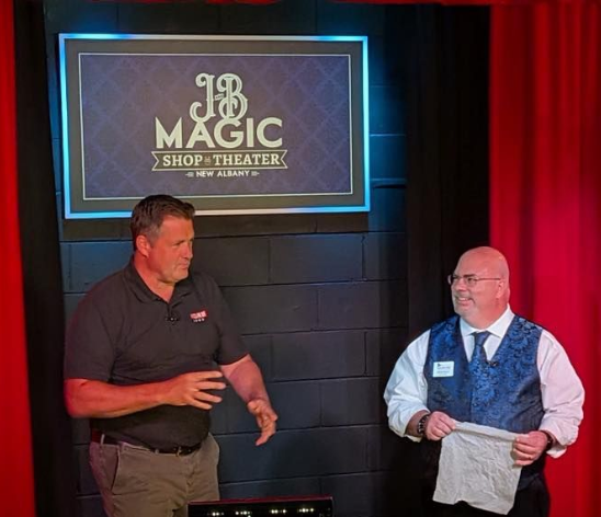 two men standing on a stage 