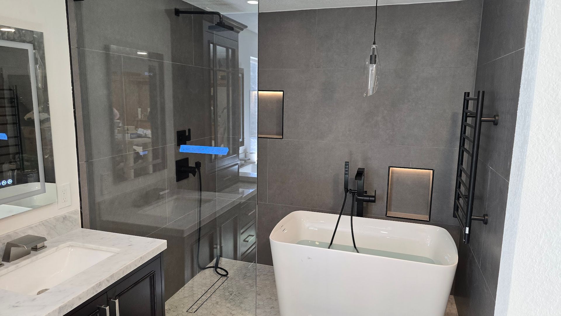 A man in a plaid shirt is using a laptop