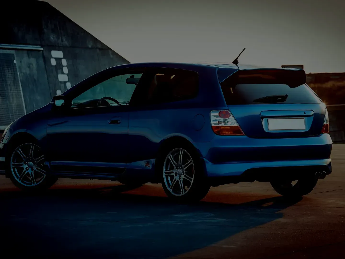 Blue hatchback car parked outdoors at dusk. | Automotive Excellence