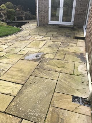 Natural sandstone patio before cleaning in Poole, Dorset with All Surface Care