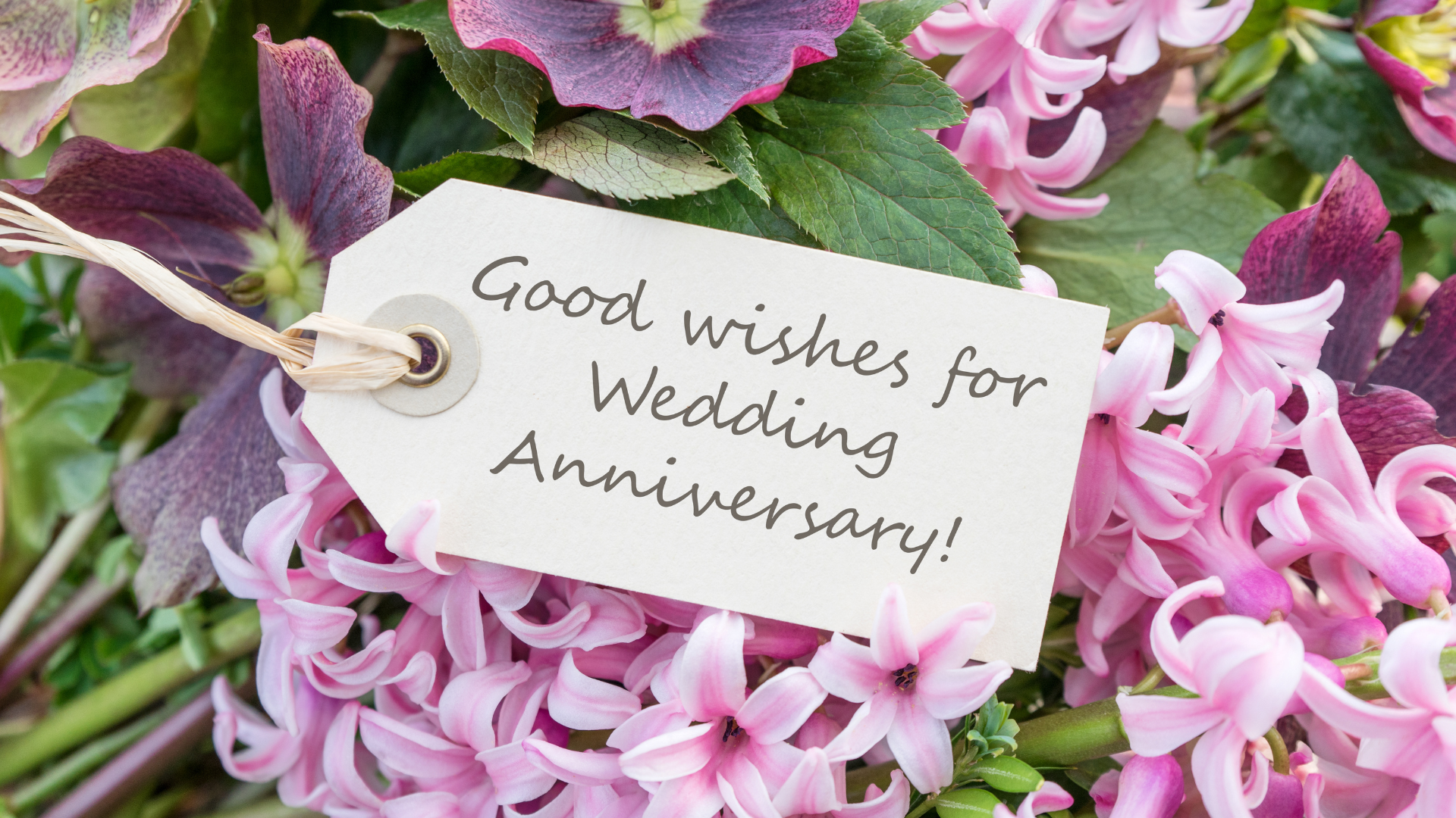 A bouquet of flowers with a tag that says `` good wishes for wedding anniversary ''