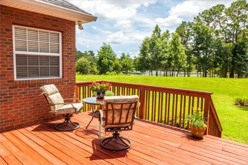 Backyard deck overlooking lake outside residential structure