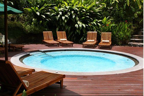 Lounge chairs surround a giant hot tub