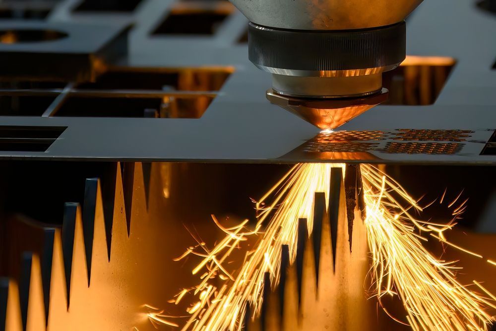 Laser cutting metal, producing bright sparks and molten material.