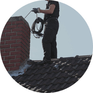 Roofing contractor conducting a chimney inspection