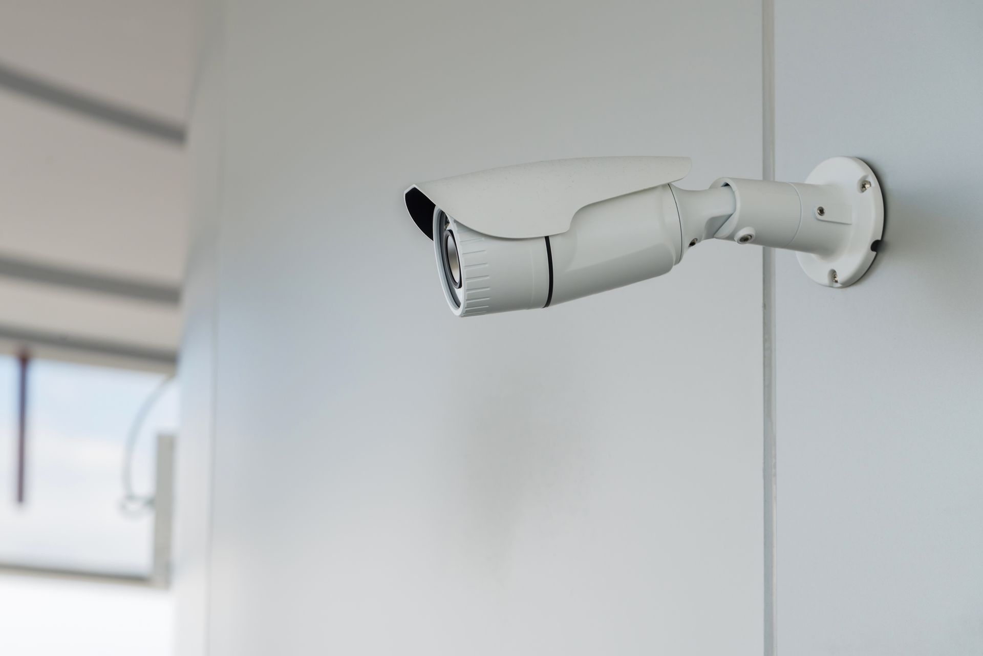 A security camera is mounted on a white wall. — Cairns, QLD — Cairns Security Monitoring Pty Ltd