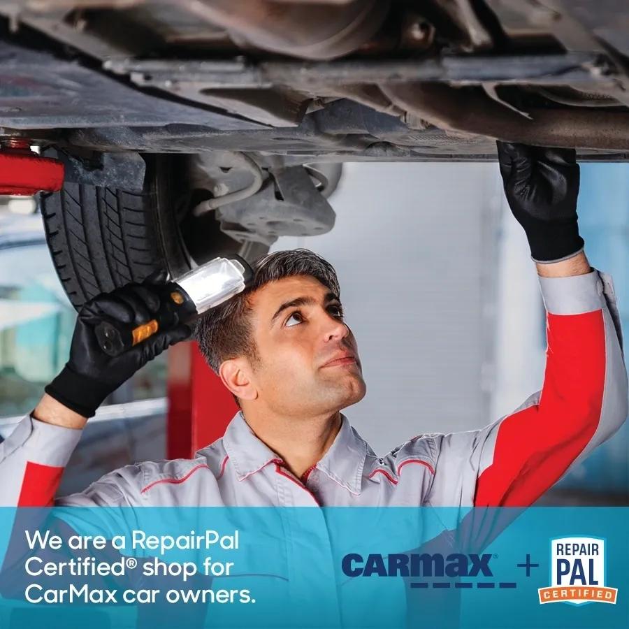 Mechanic under a car, using a flashlight. Ad promoting RepairPal Certified service for CarMax owners. | Equality Automotive