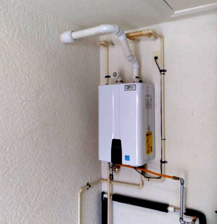 Man Installing New Water Heater — Naples, FL — SunWest All Service Inc.