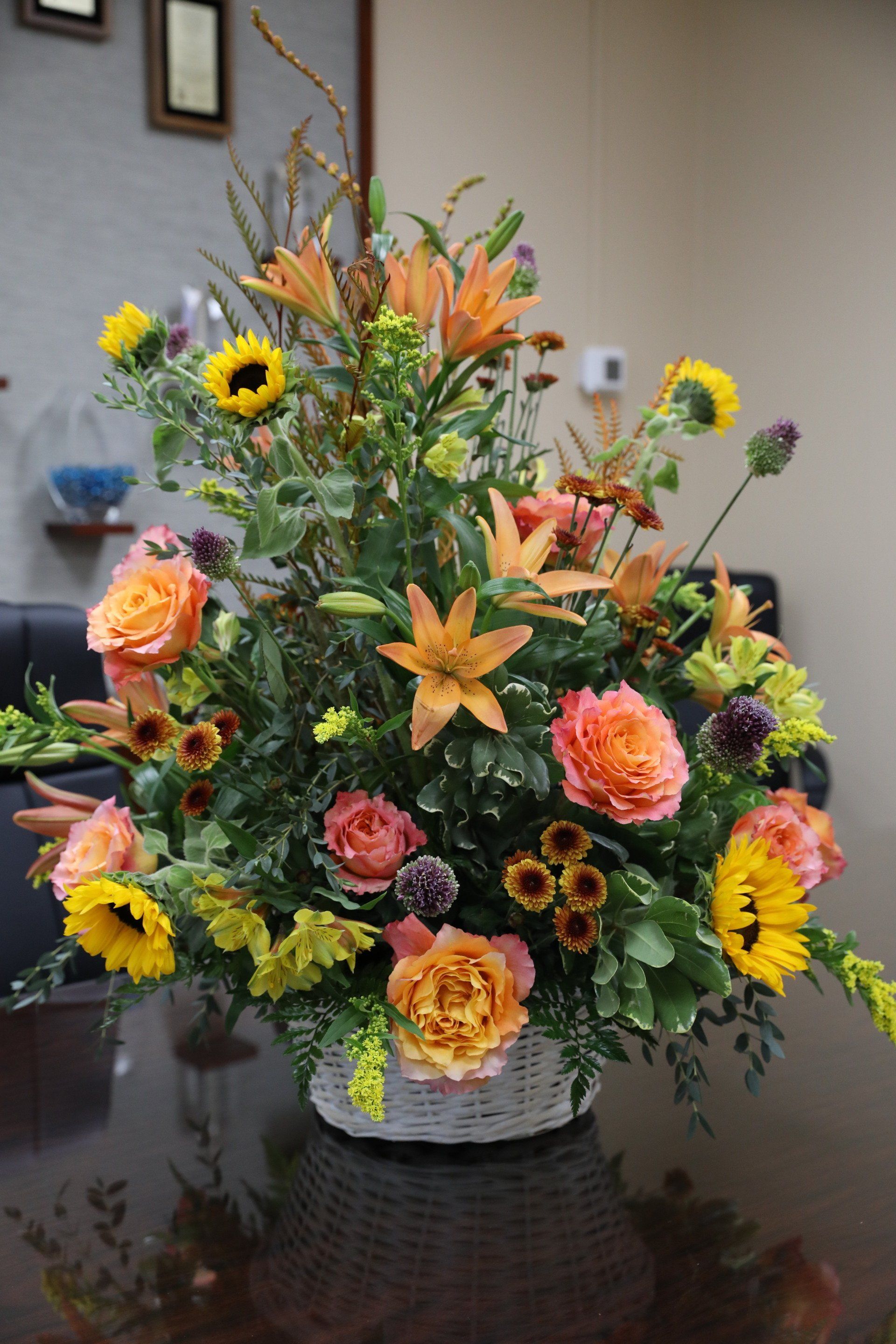 A basket filled with flowers is sitting on a table.