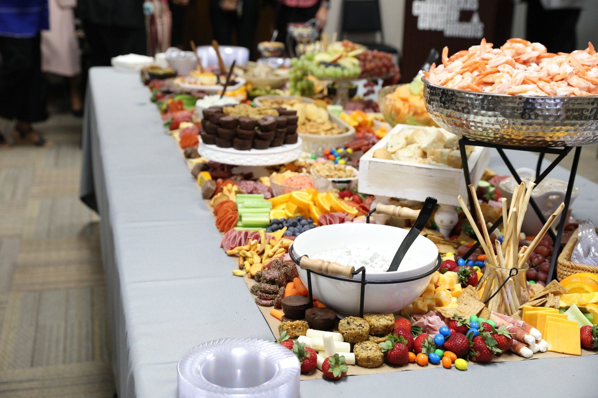 A long buffet table filled with lots of food and drinks.