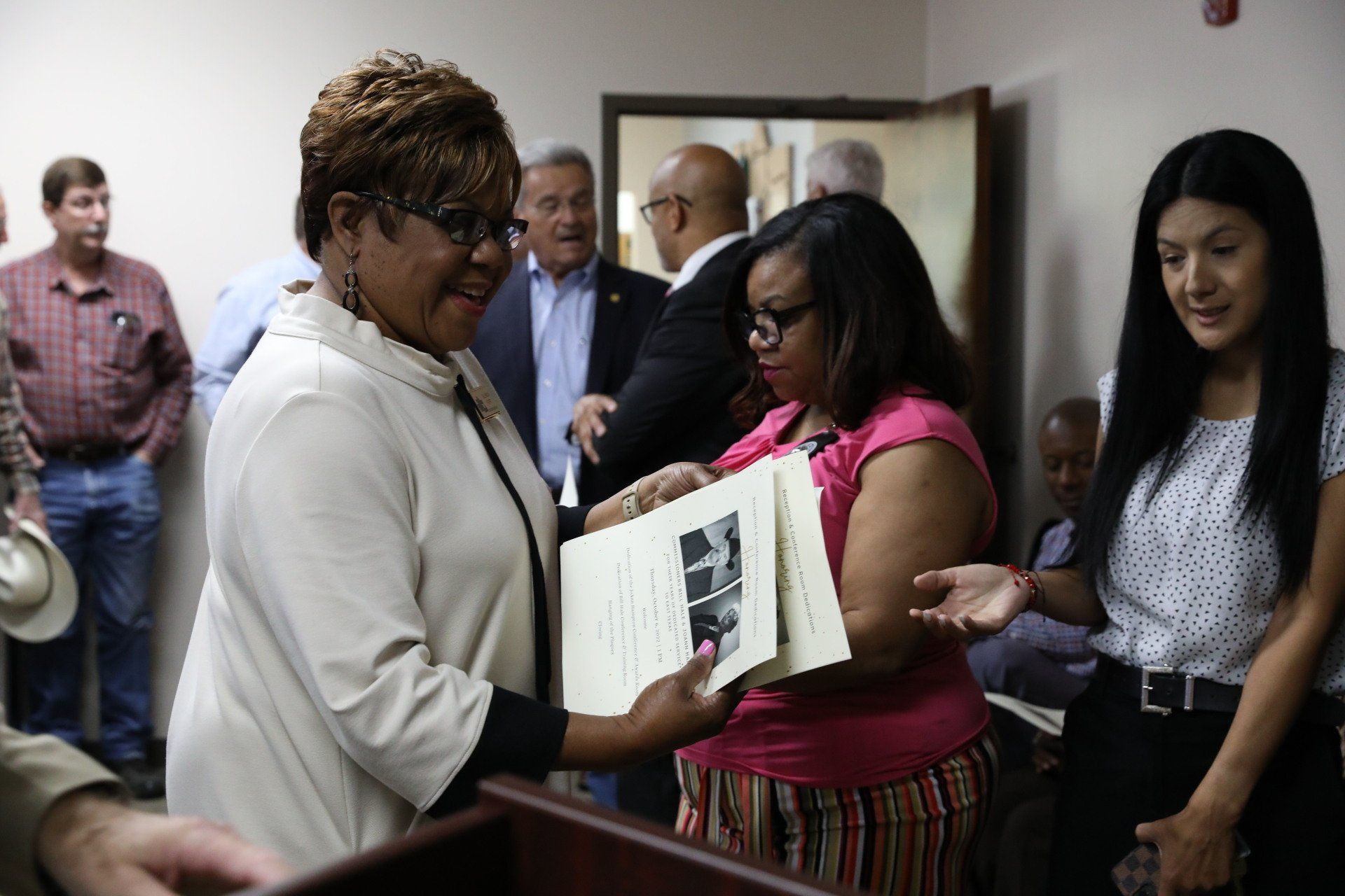 A woman is giving a certificate to another woman