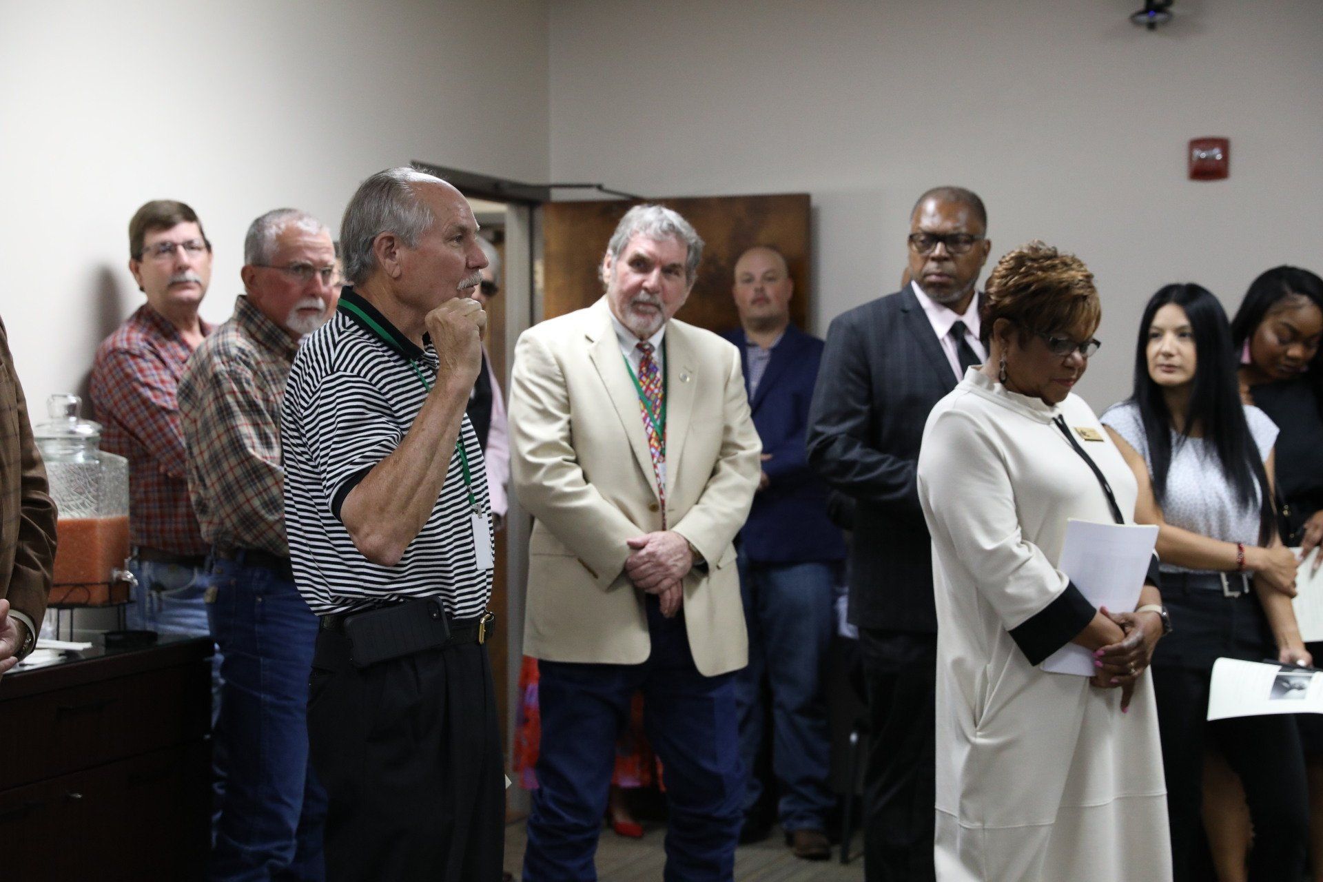 A group of people are standing in a room.