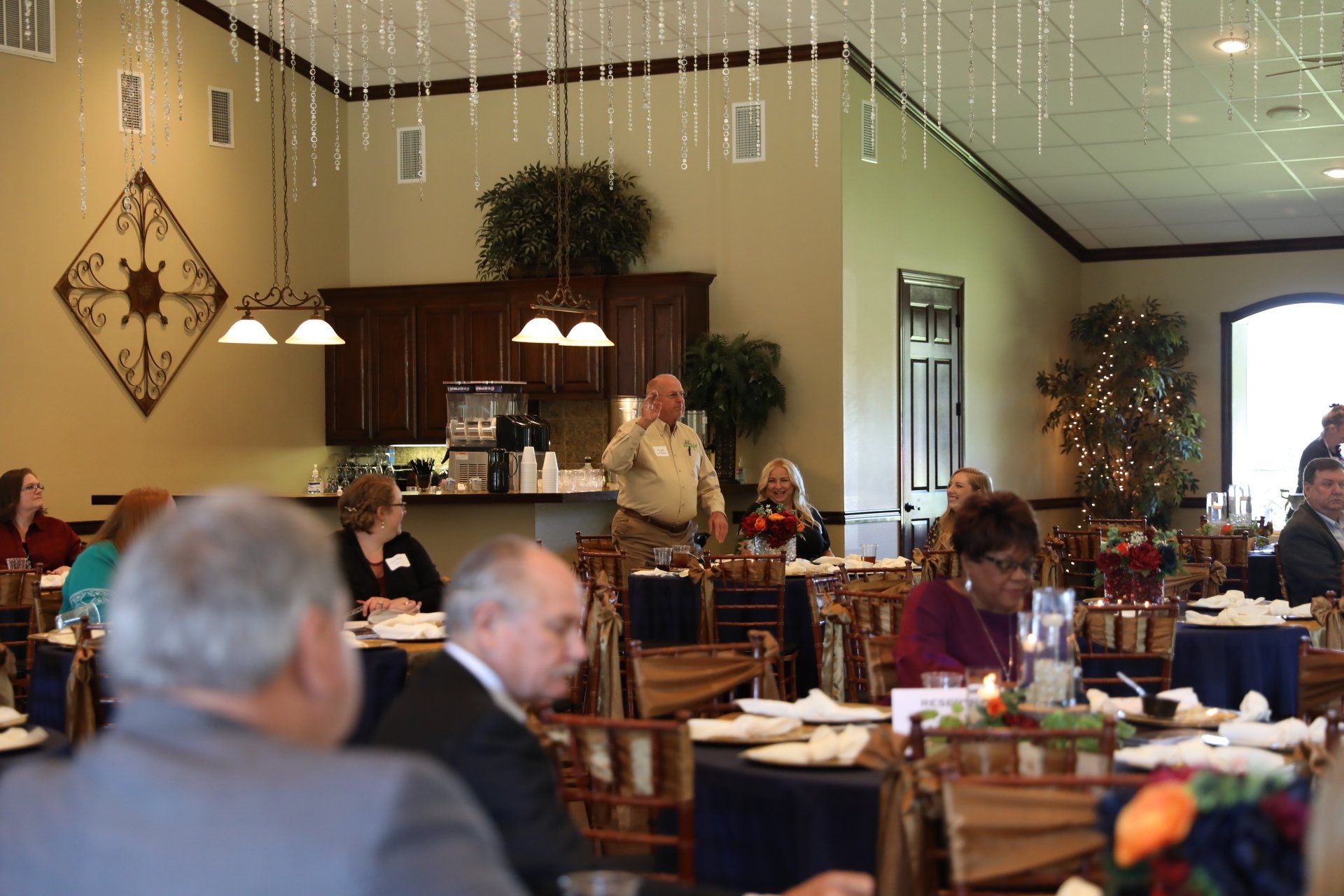 A group of people are sitting at tables in a restaurant