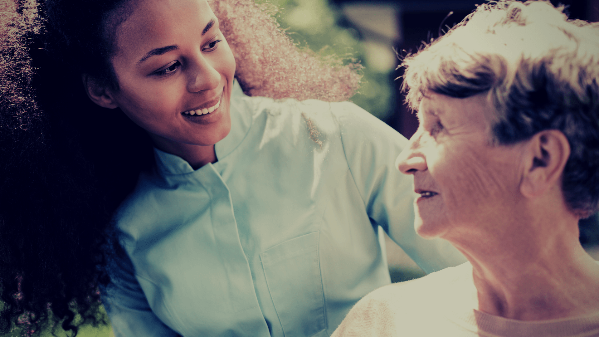 A young woman is talking to an older woman.