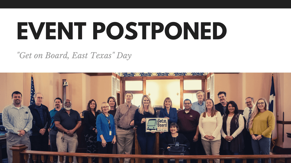 A group of people standing in front of a sign that says event postponed