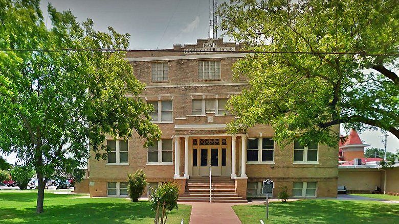 A large brick building with trees in front of it
