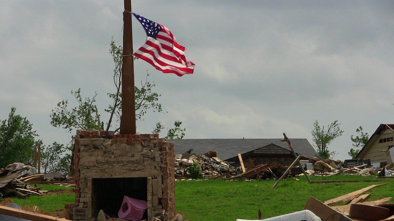 An american flag is flying over a brick fireplace