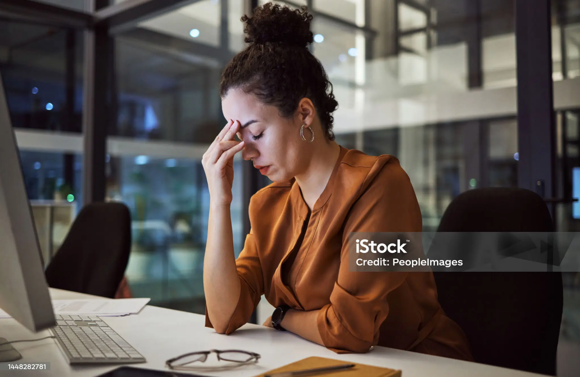 Frustrated employee sitting at a desk, concerned about wrongful dismissal.