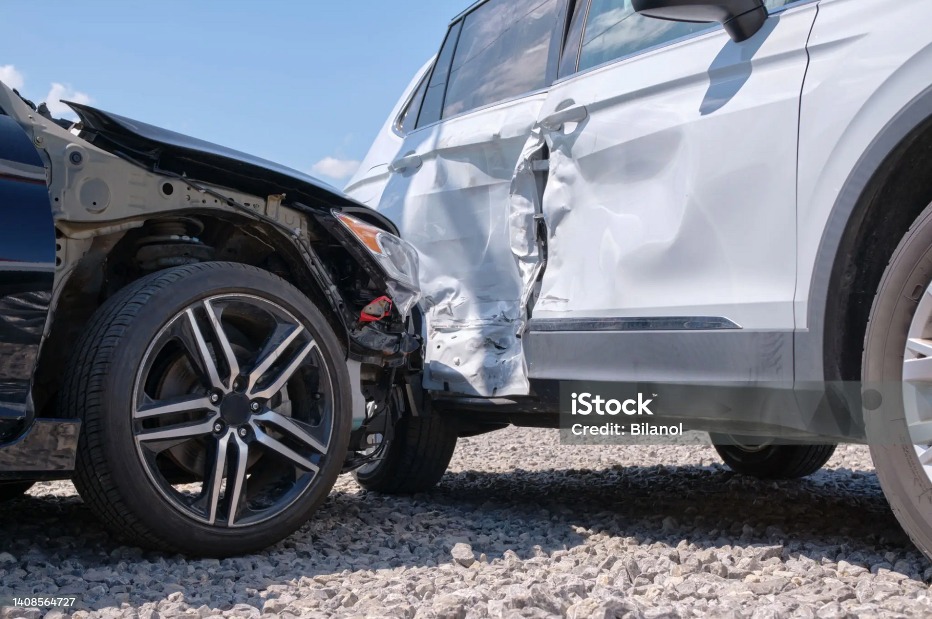 Close-up of two damaged vehicles after a car accident.