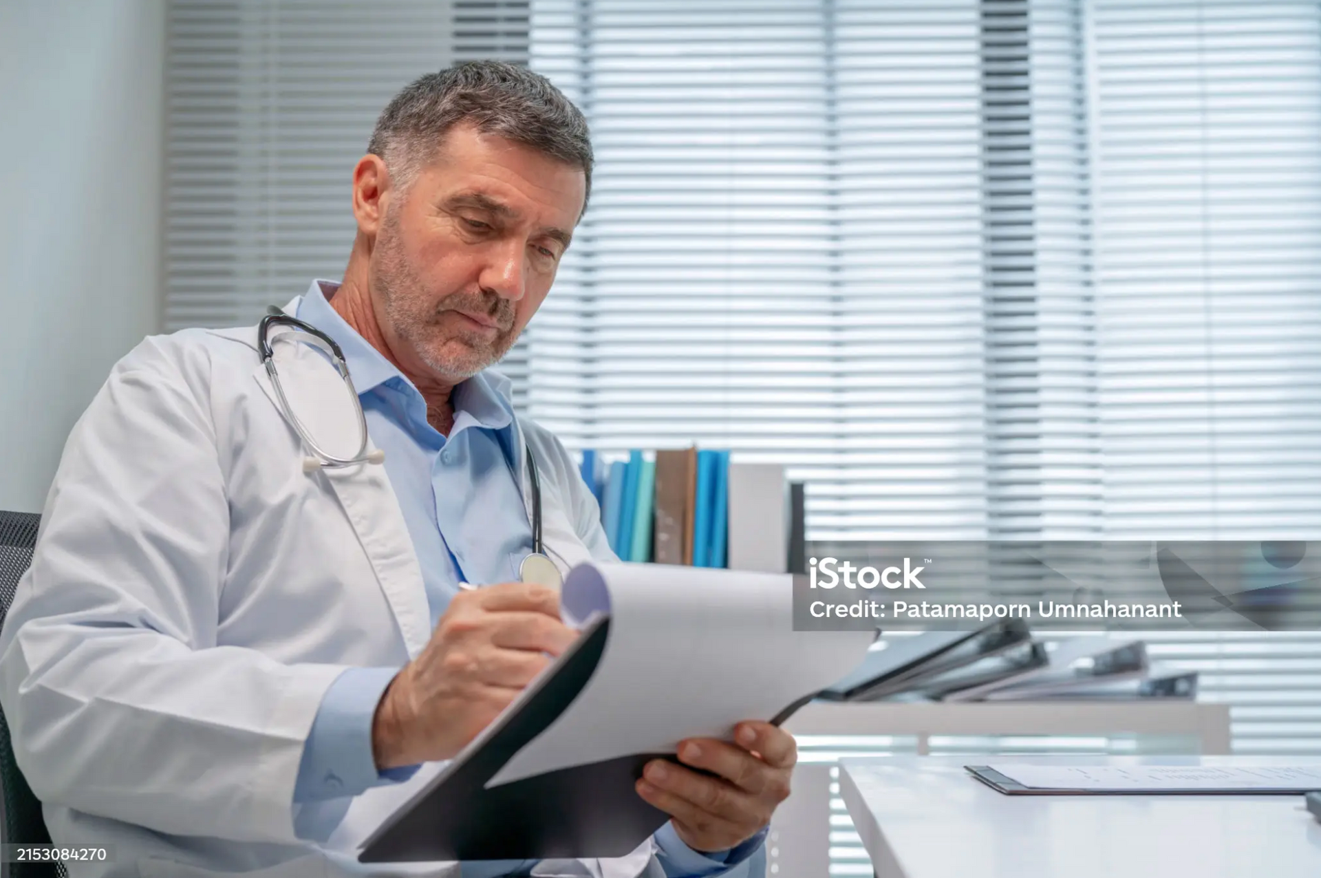 A doctor reviewing medical documentation for a disability claim.