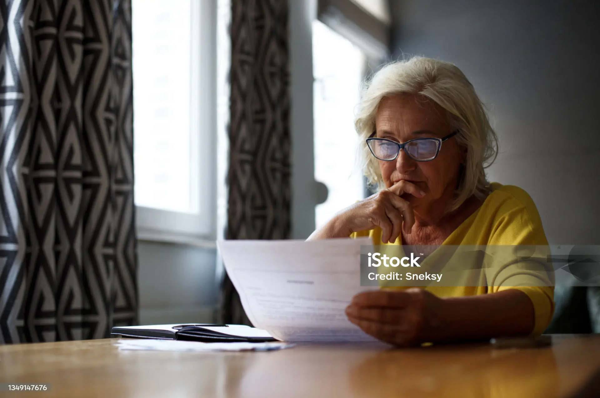 Concerned woman reading a long-term disability claim denial letter.