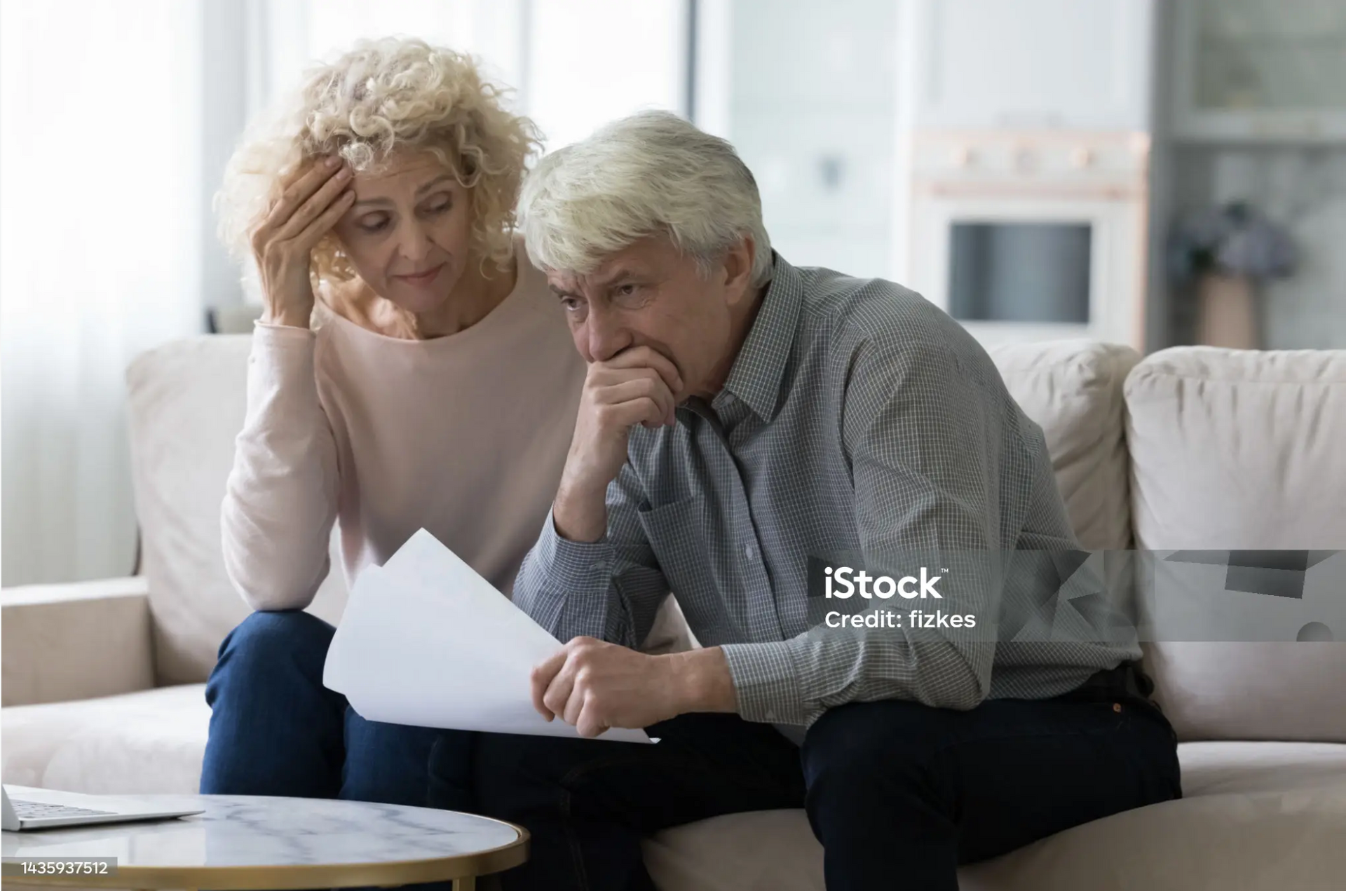 Family looking concerned while reviewing life insurance claim documents.