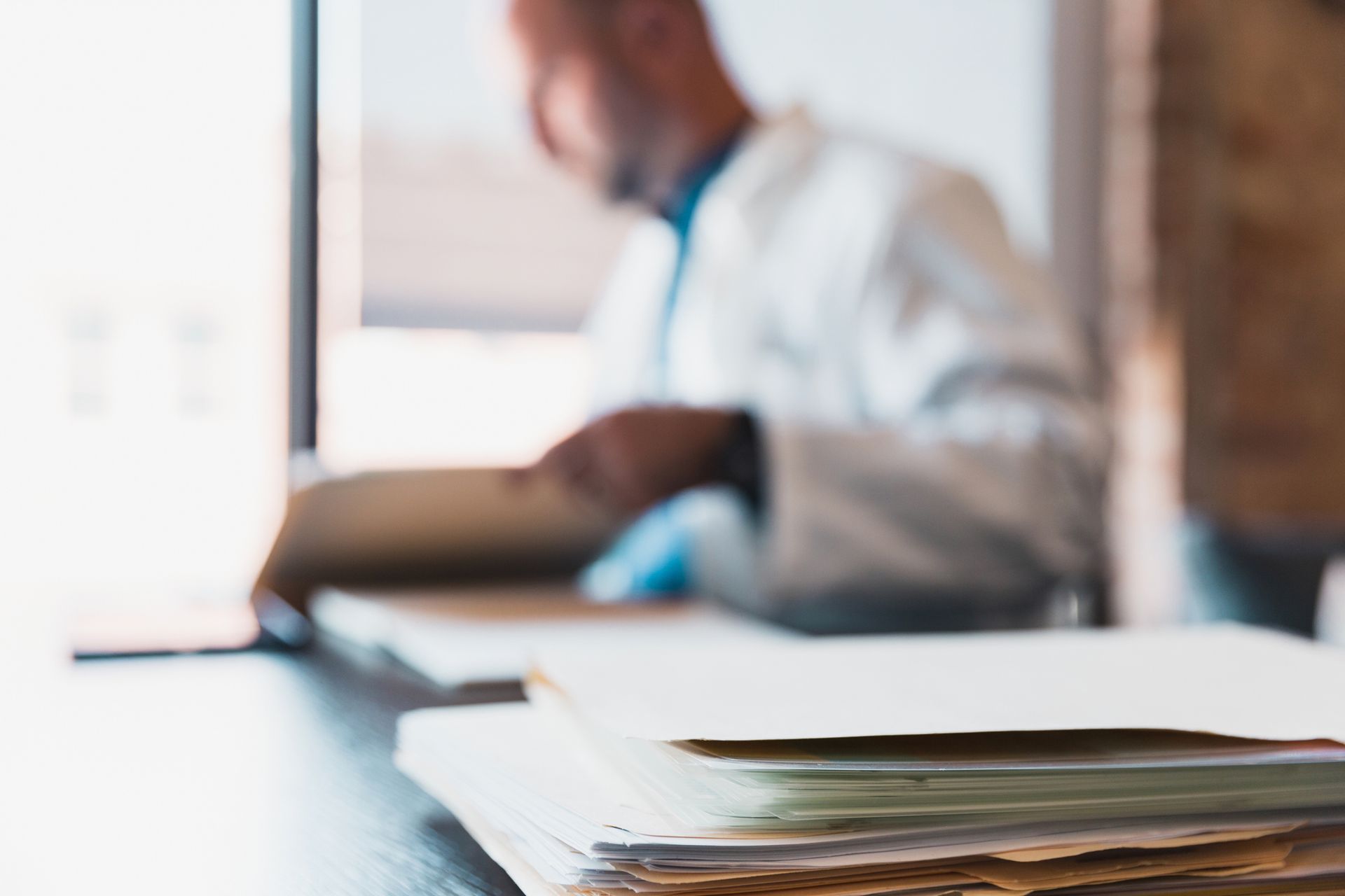 Stack of medical documents and doctor's notes required for mental health disability claims.