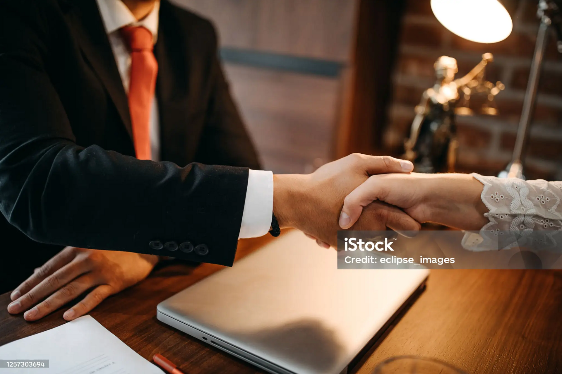 Handshake between a lawyer and client after a successful legal consultation.