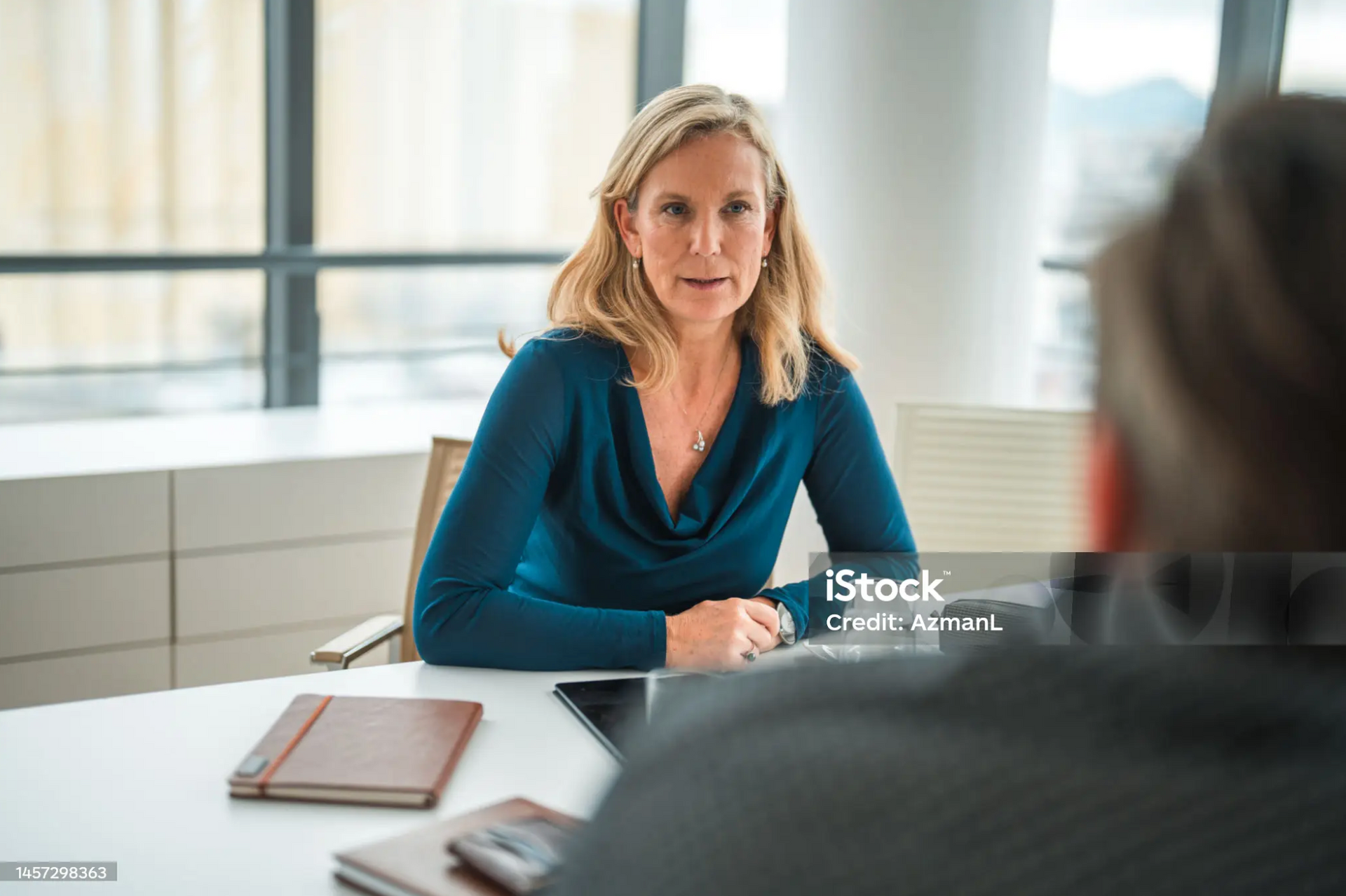 Lawyer advising a client on employment law matters in an office.