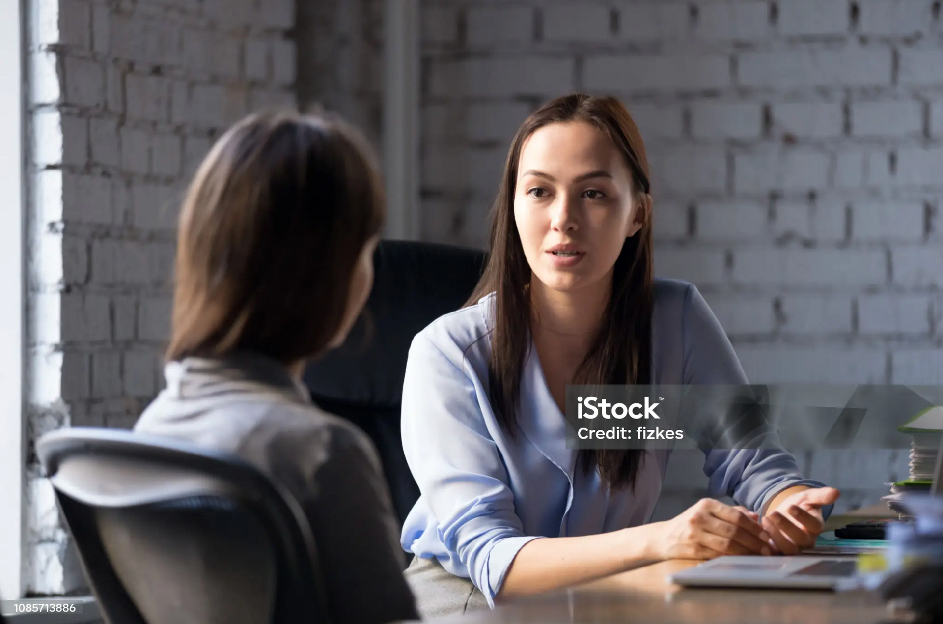 Lawyer discussing a slip and fall case with a client at a law firm.