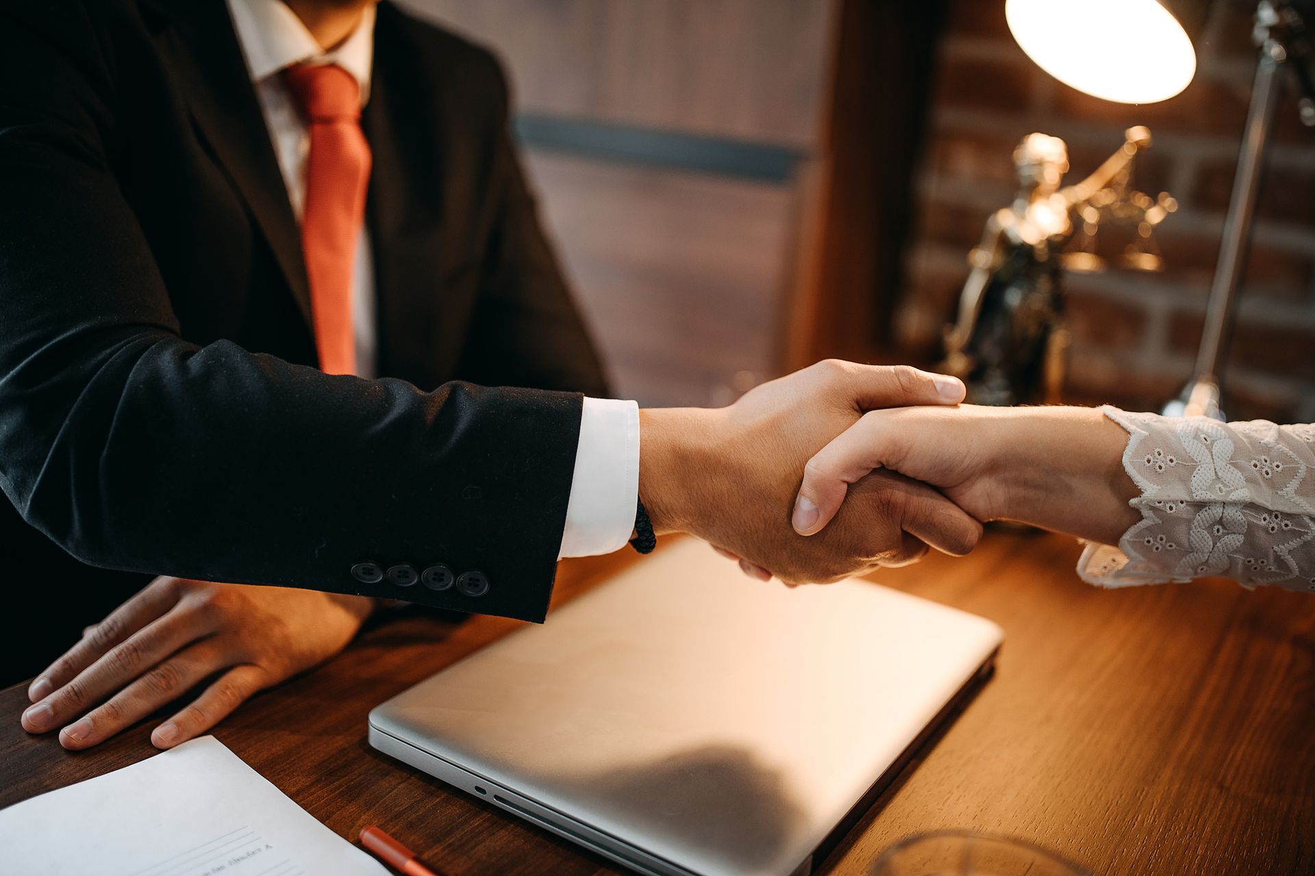 Handshake between a lawyer and client after a successful legal consultation.