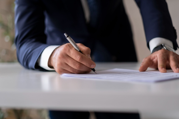 A Toronto car accident lawyer signing documents.