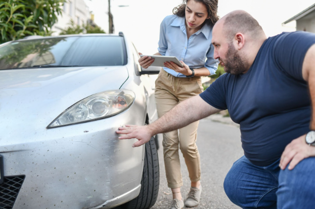 Man showing his car accident lawyer the damage to his vehicle after getting into an accident.