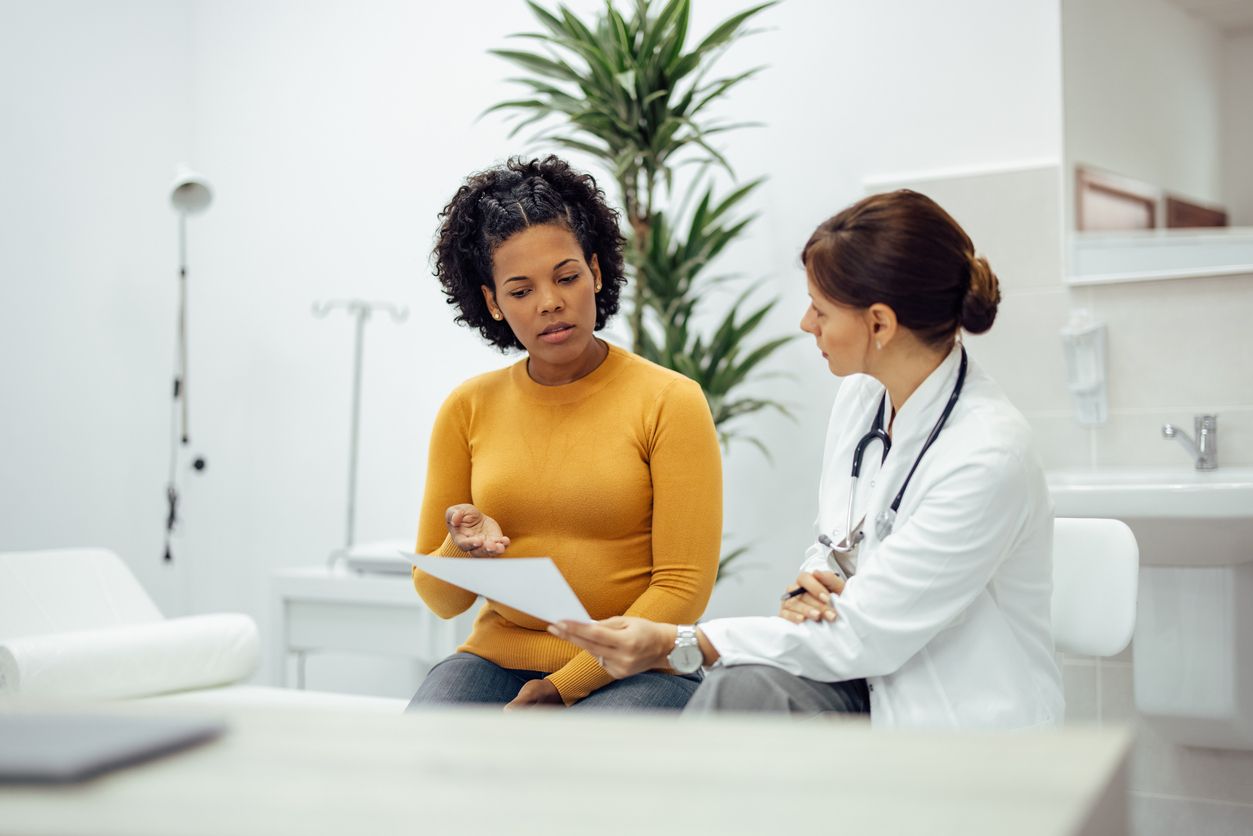 A doctor discusses partial disability diagnosis with a patient in a clinical setting, highlighting an important step in the Ontario long-term disability process.