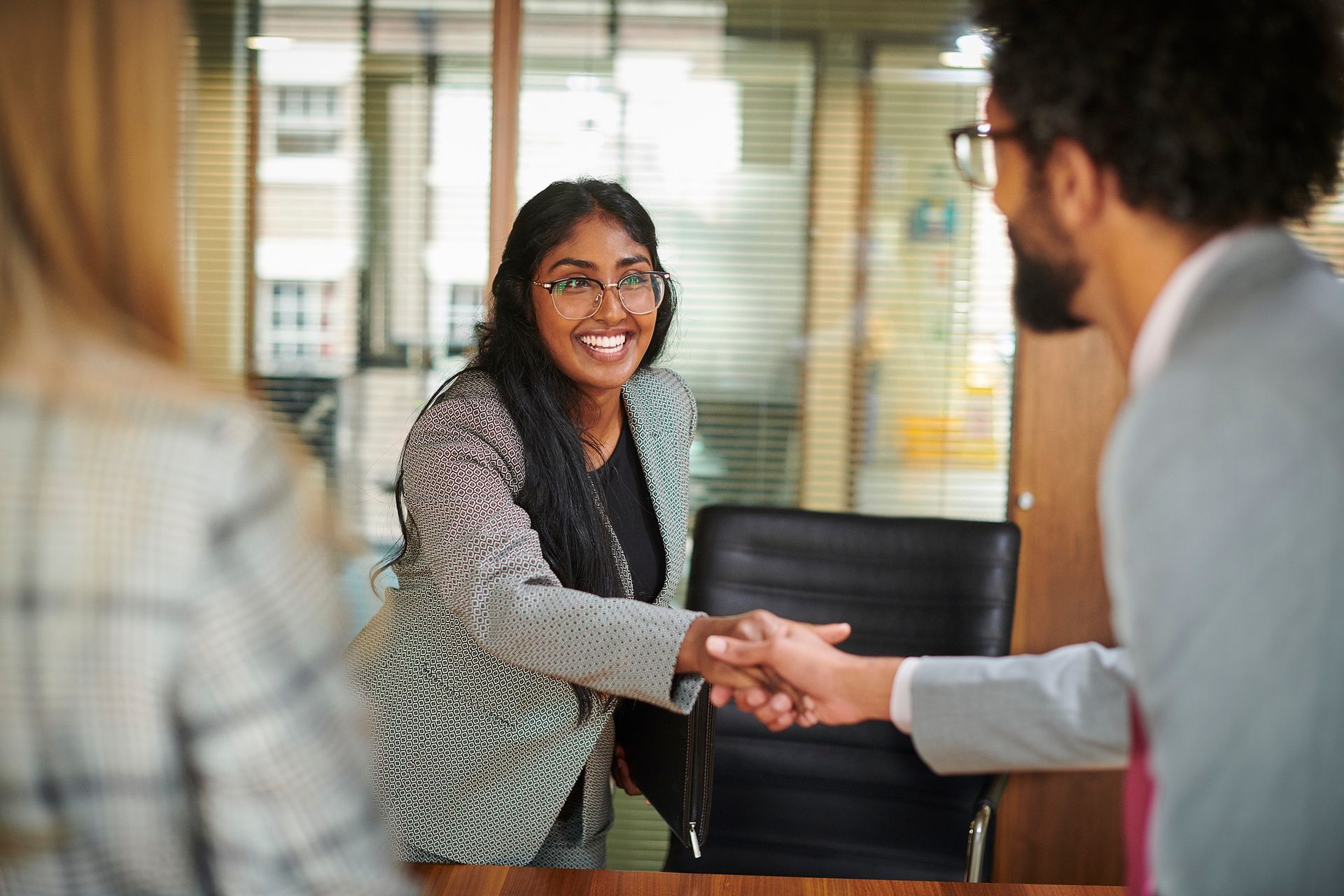 Woman shaking the hand of an employment lawyer in Toronto.