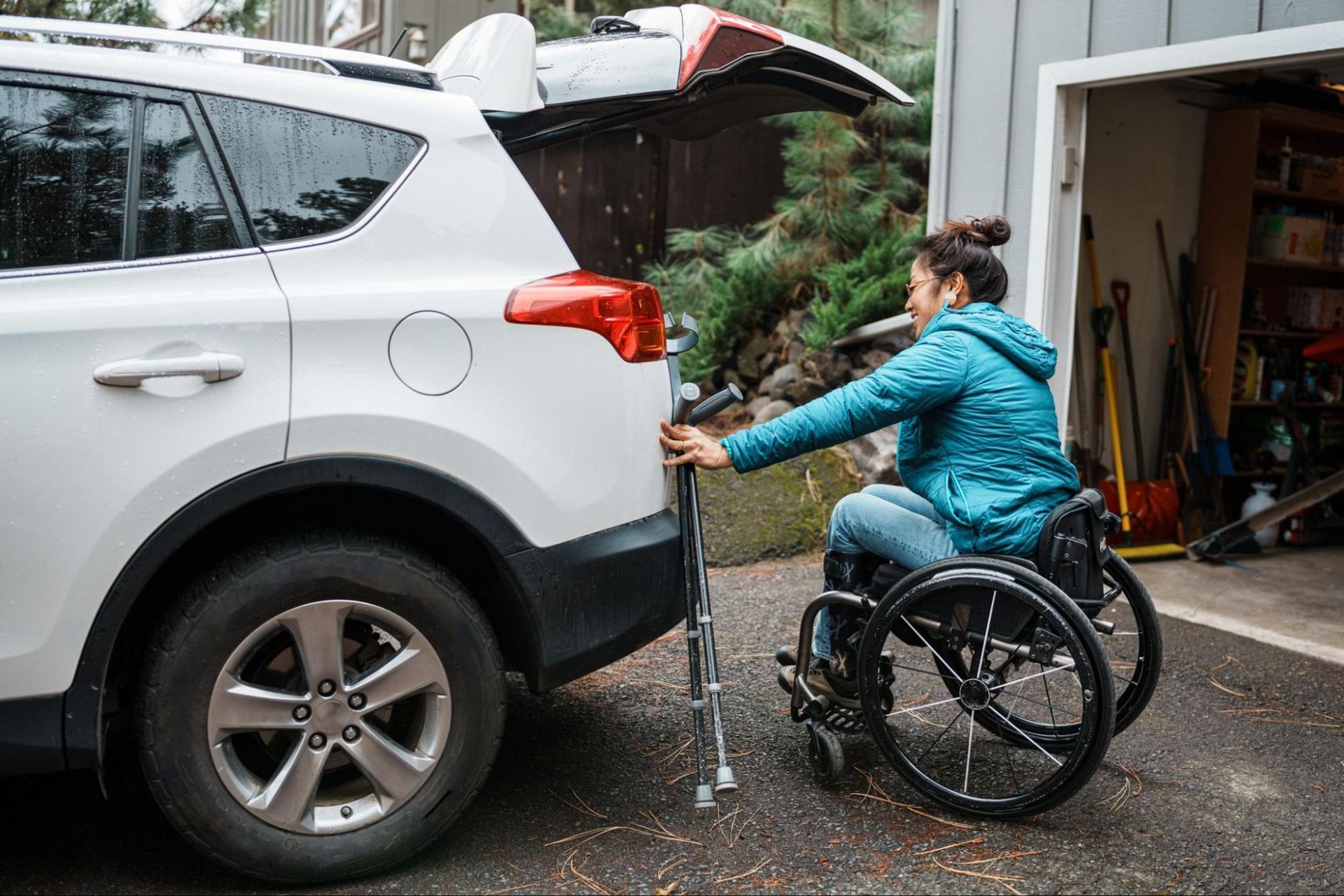 Woman in wheelchair accessing her vehicle.