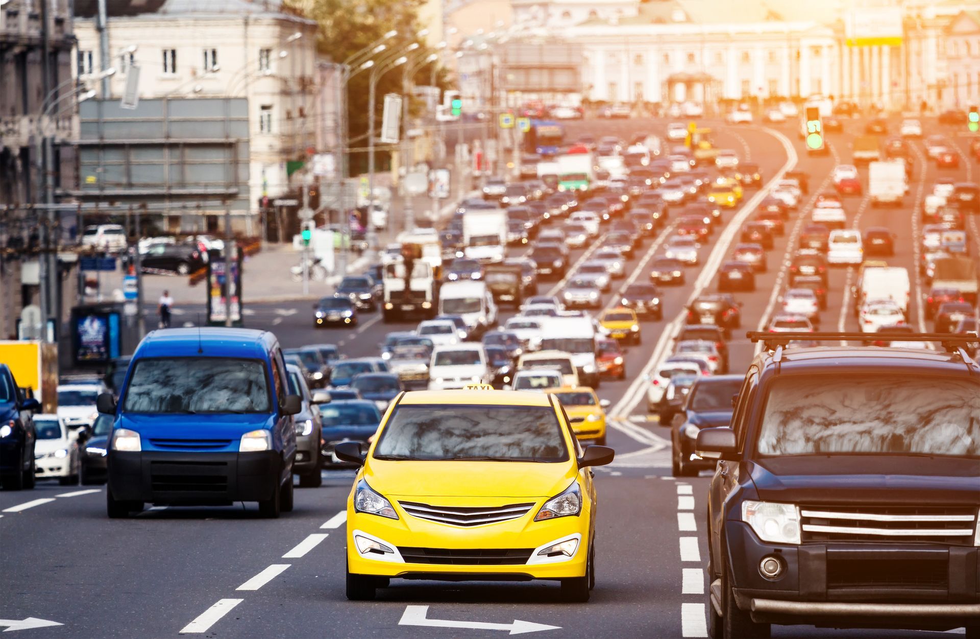 A busy urban street filled with cars in multiple lanes during peak traffic hours.