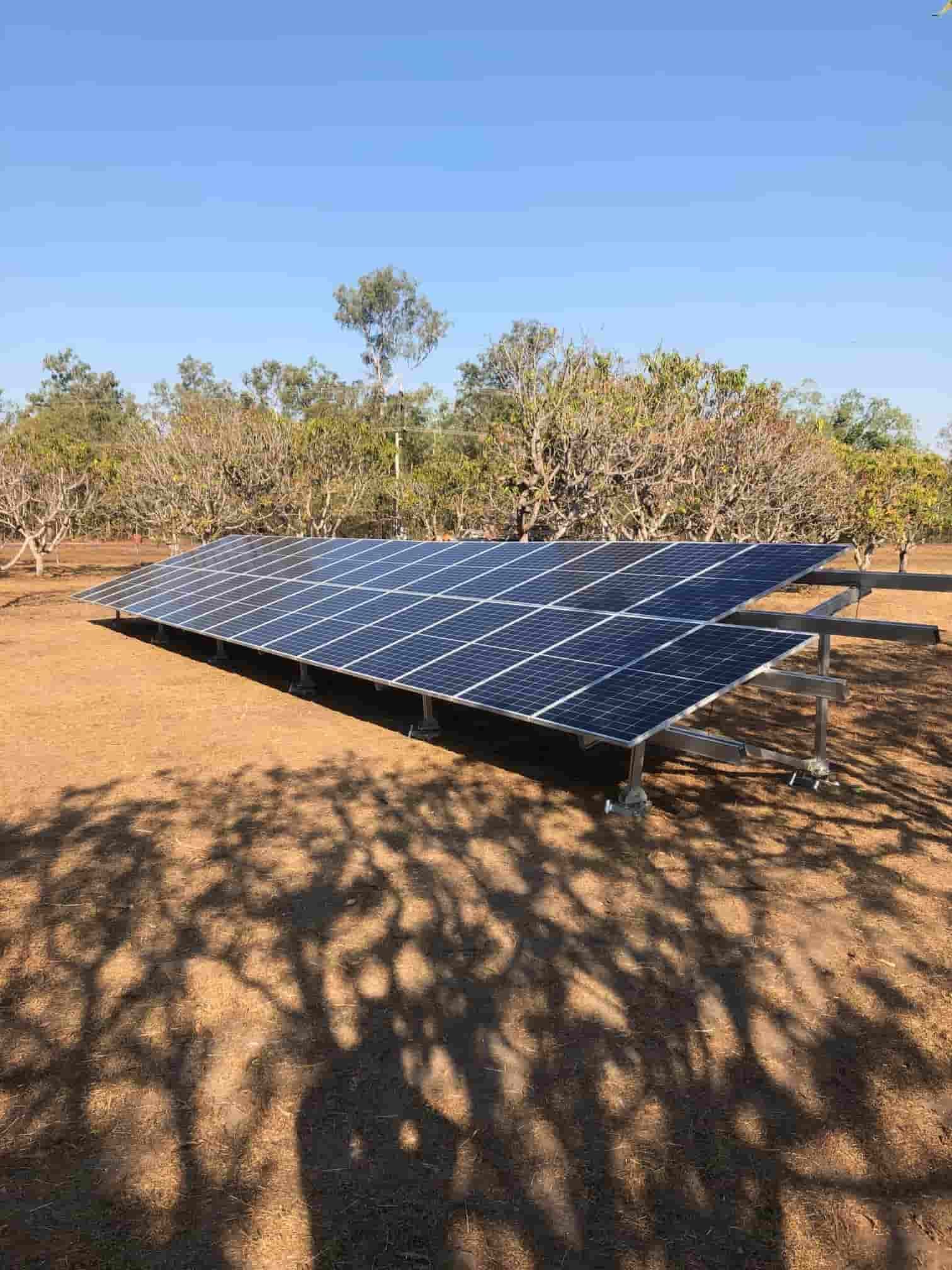A Row of Solar Panels Sitting on Top of a Dirt Field — Eco Sparks Solar & Electrical Contractors in Berrimah, NT